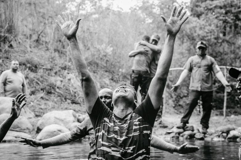 people jumping into a stream to reach for soing