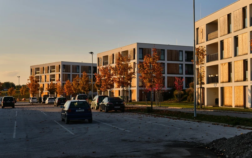 cars driving past a building on an empty street