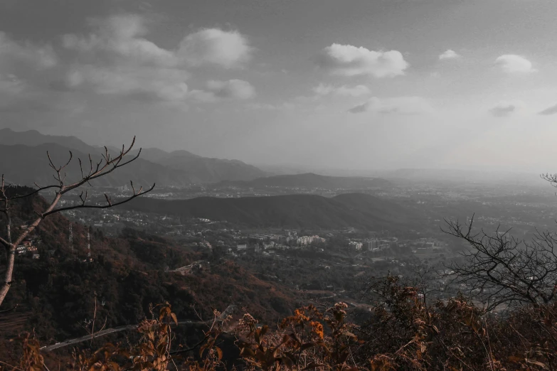 some black and white mountains and trees and clouds