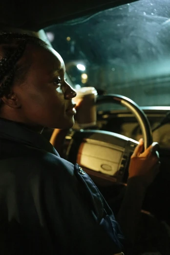 a woman driving at night while holding the steering wheel