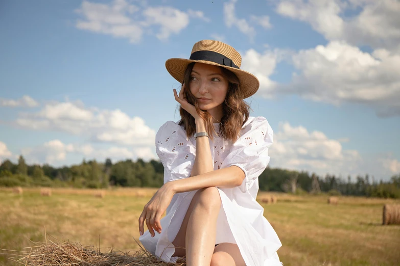 woman in dress and hat posing for po