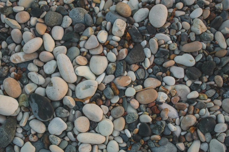 a large amount of rocks with white and black ones