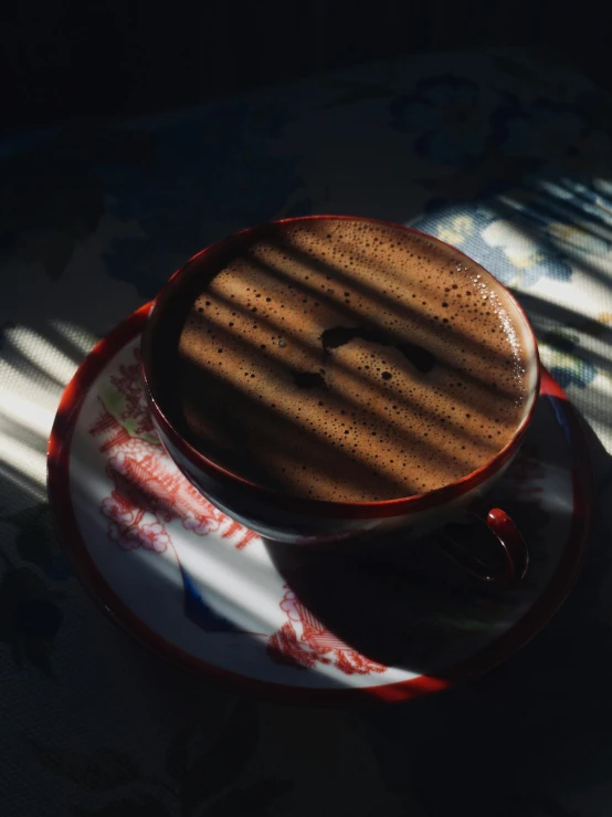 a  chocolate in a cup with a plate underneath