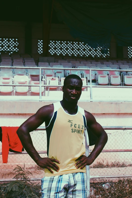 a man standing on a stadium field next to the bleachers