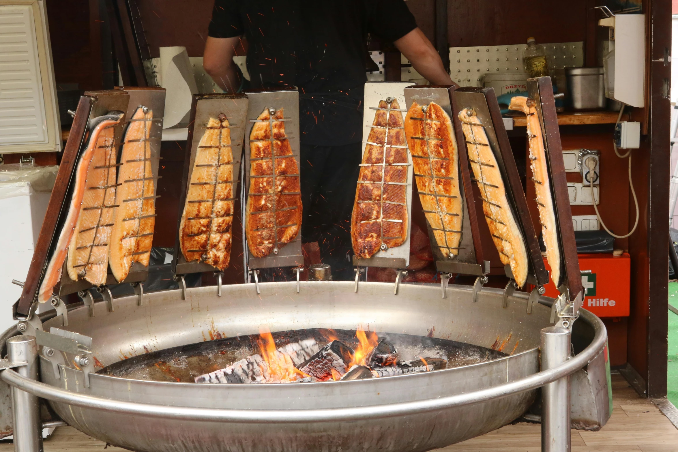 a large silver grill with various skewers on it