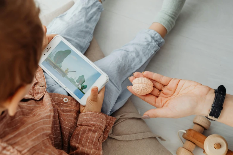 a woman uses a tablet with her foot up on the floor