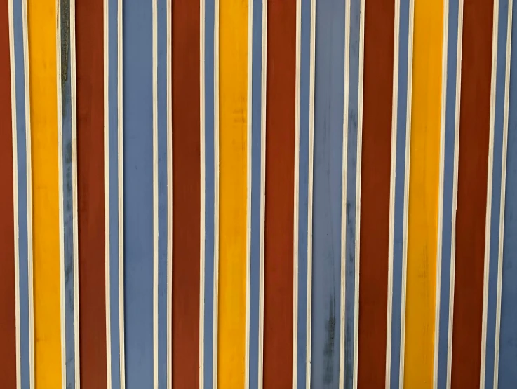 a striped wall painted with blue, yellow and red