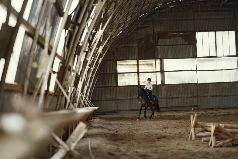 an equestrian rider is on the back of a horse in an arena