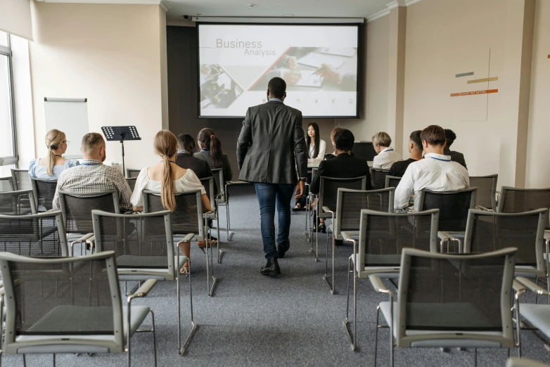 a man is walking through a conference room