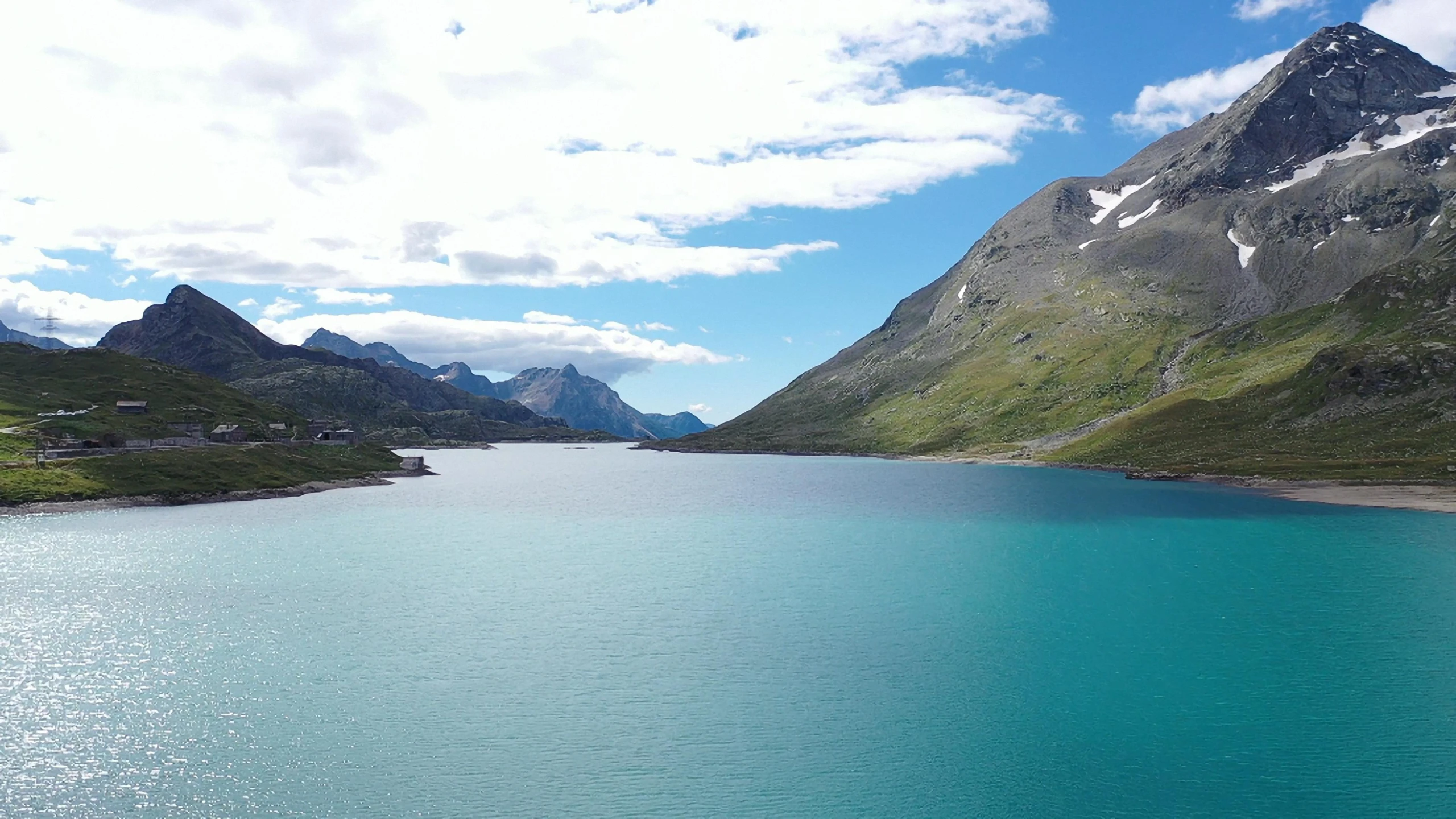 the blue lake is surrounded by some mountains