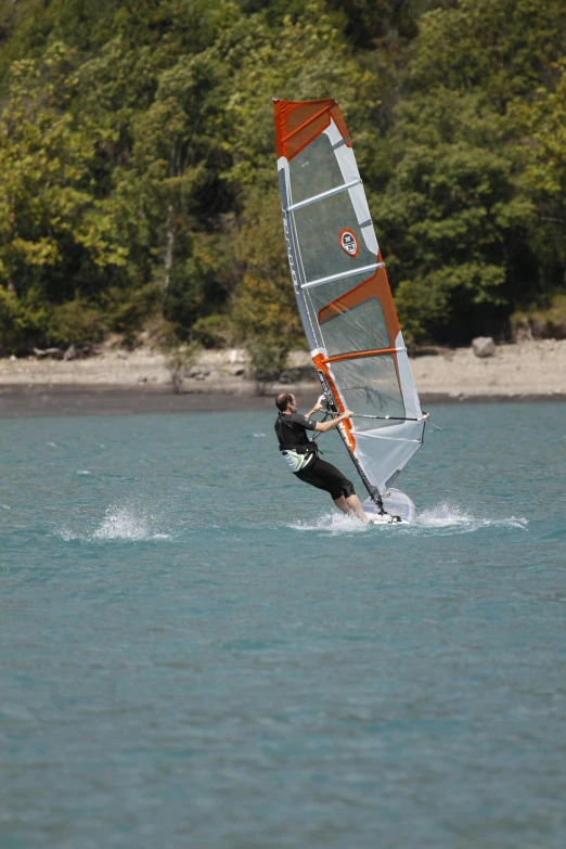 a man riding on top of a sail board