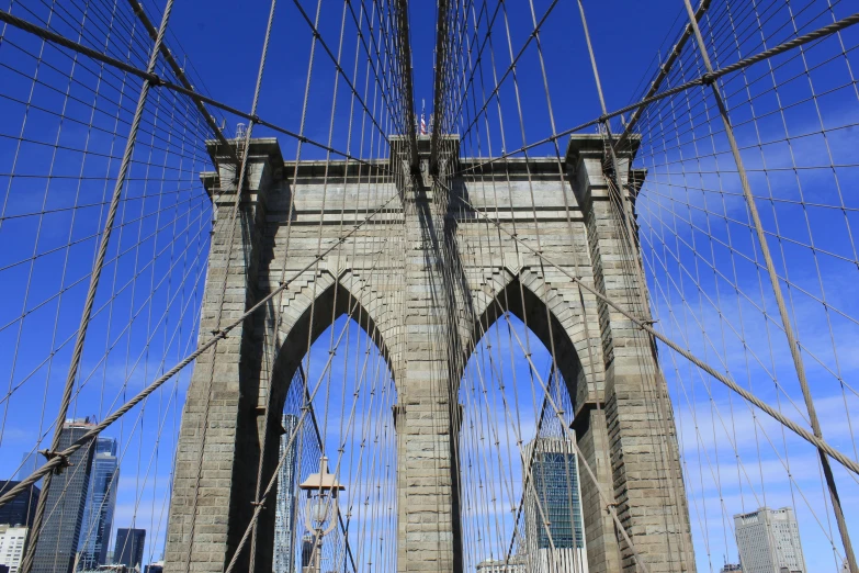 the top of a very tall bridge that has lots of cables