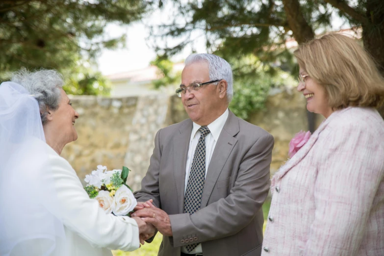 an old man greeting another older woman in her wedding dress
