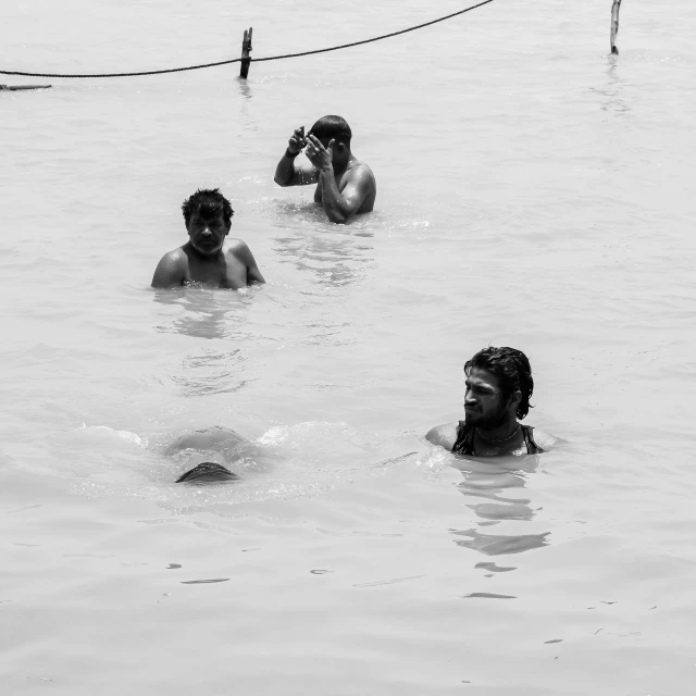 two young men are in the water looking up