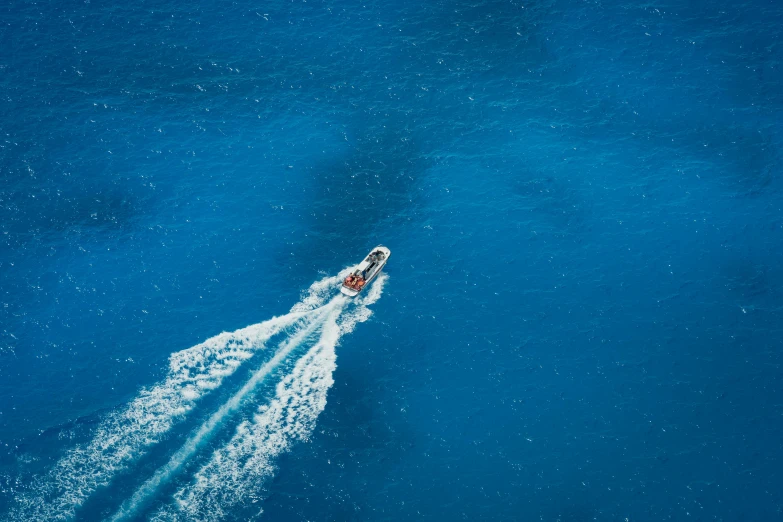 a boat in the water leaving a lot of spray