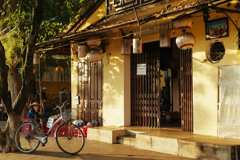 a bike parked in front of a yellow building