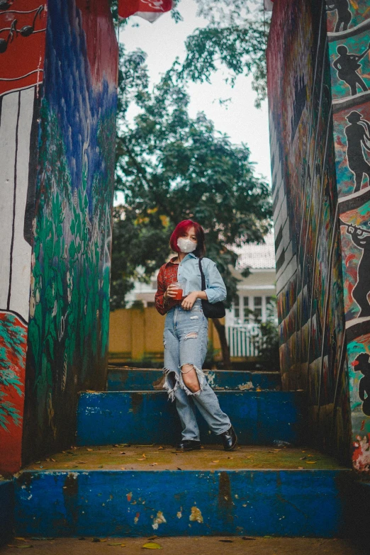 a girl posing on some steps with a backpack