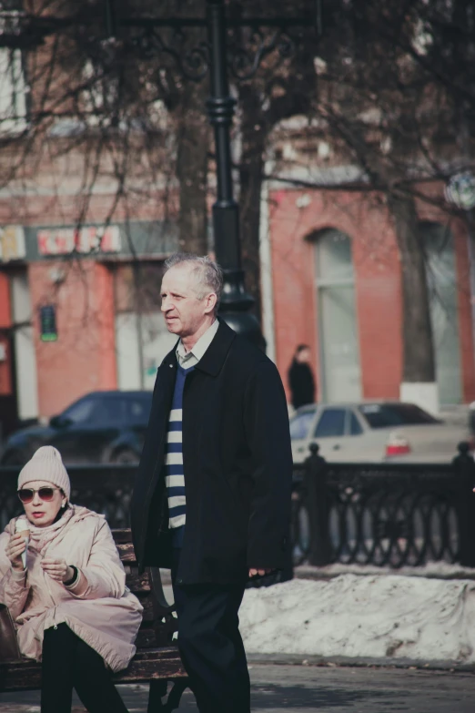 two people walking across a street together