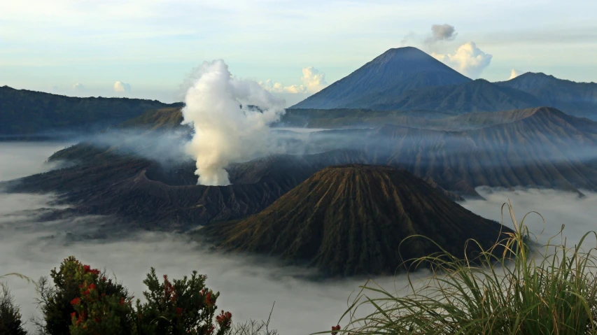 an aerial s of a mountain range with steam coming out of it