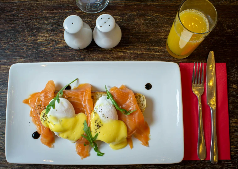 a white plate topped with eggs and salmon