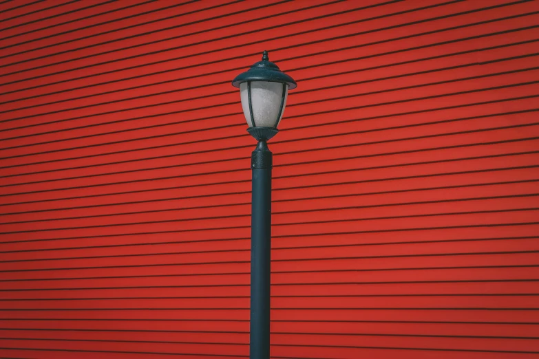 a lamp pole sitting next to a building