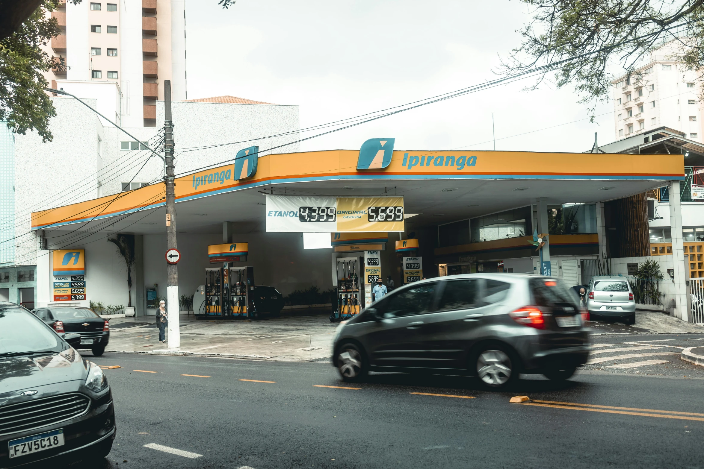 a gas station with some cars parked in front of it