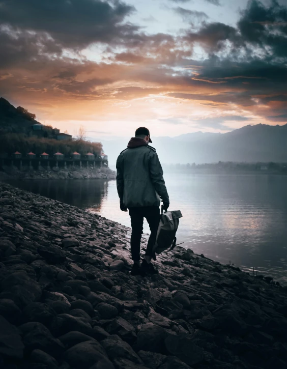 a person with a bag walking down the shore line