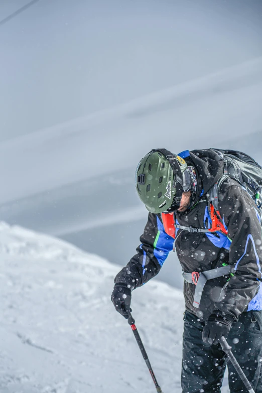 a man wearing snow gear standing in the snow