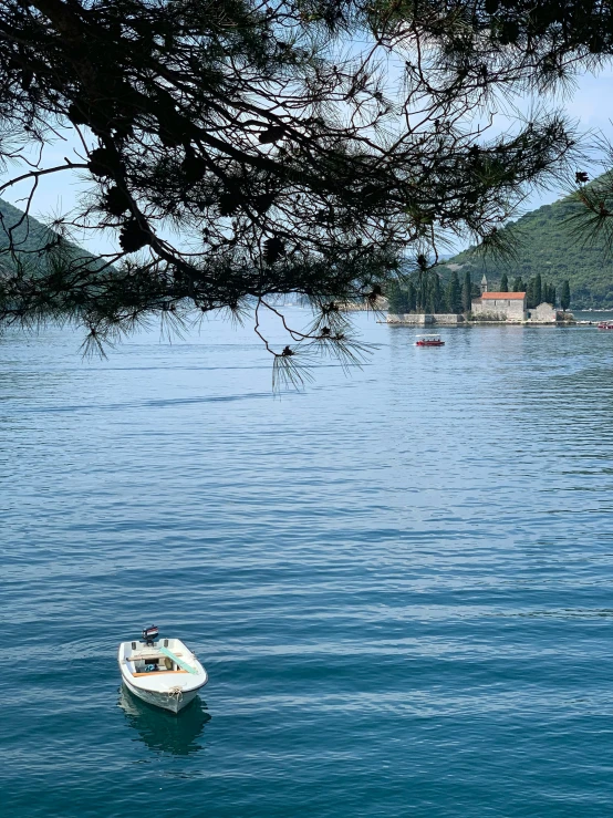 a boat on the water with land in the background