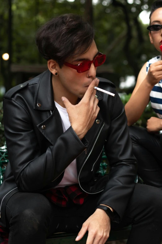 two woman sitting outside smoking cigarettes and talking