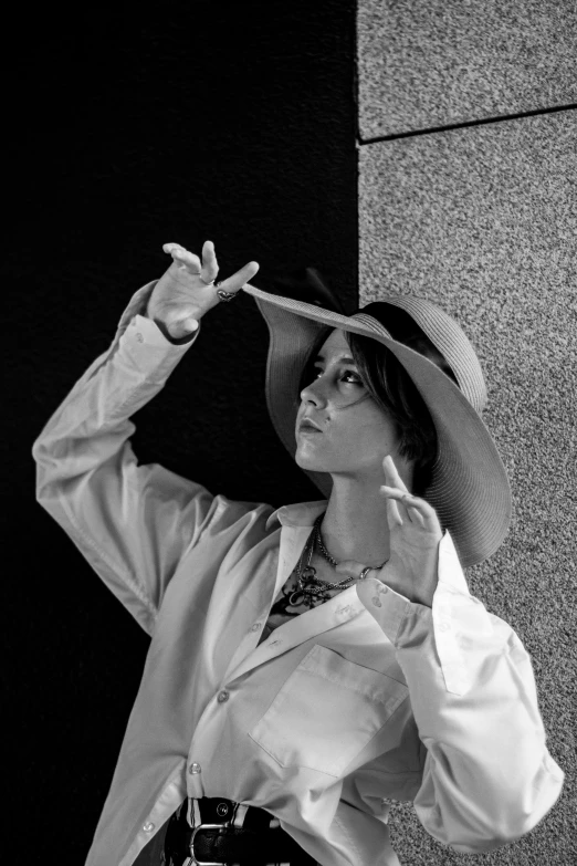 a woman wearing a hat while standing in front of a building