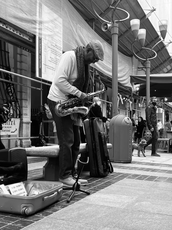 a black and white po of a man playing saxophone