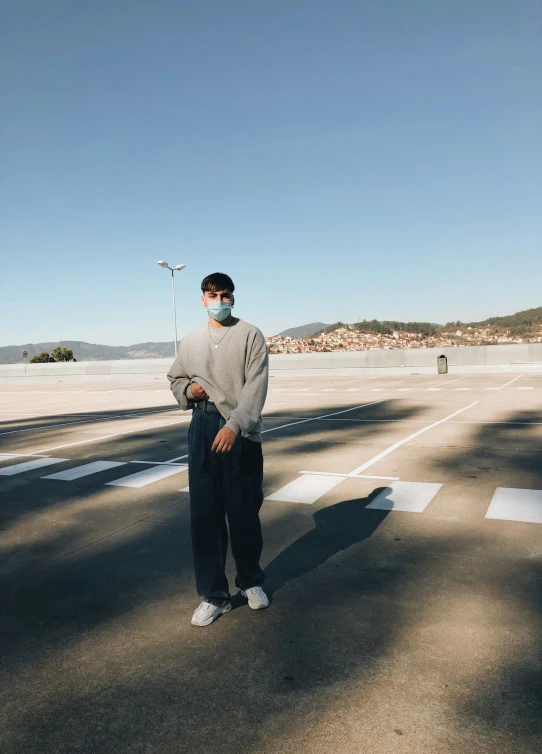 a man is standing in the middle of an empty road