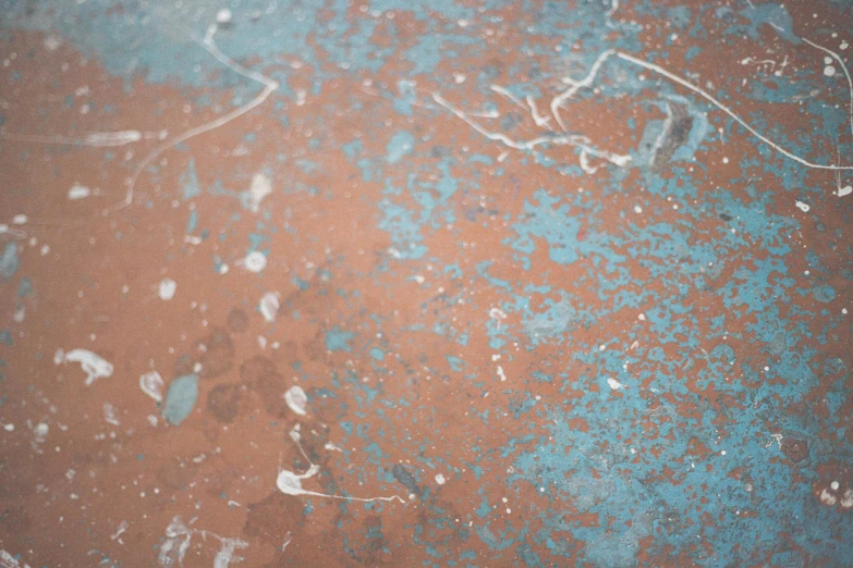 blue paint on a brown surface near the bottom