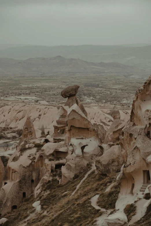 a stone building on a hill covered in dirt