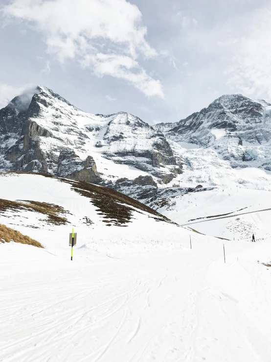 skiers trekking across a snowy mountain pass