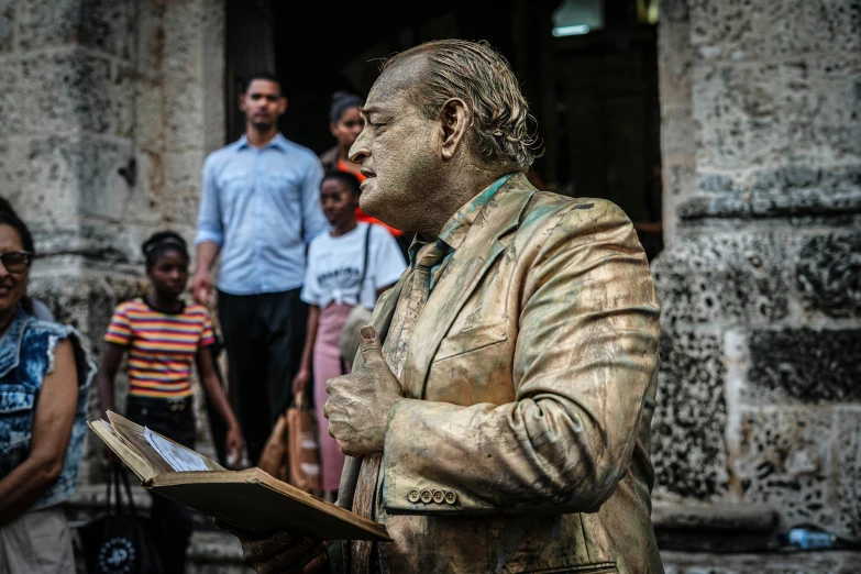 a man in a suit standing next to people