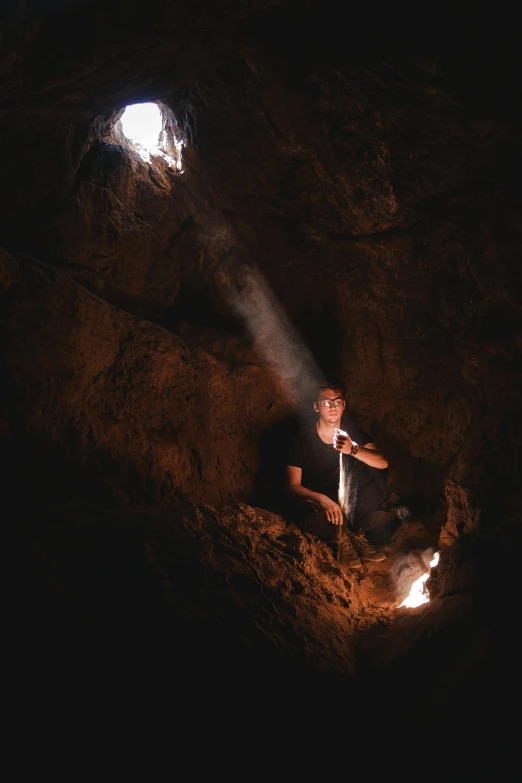 a man that is sitting down in some dirt