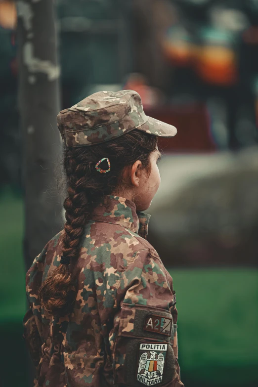 girl in uniform staring at soing in the background