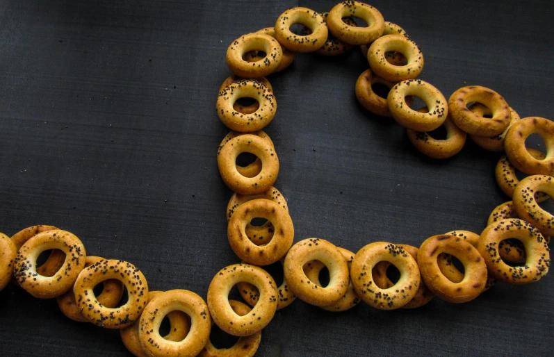 a pile of donuts sitting in the middle of a black background