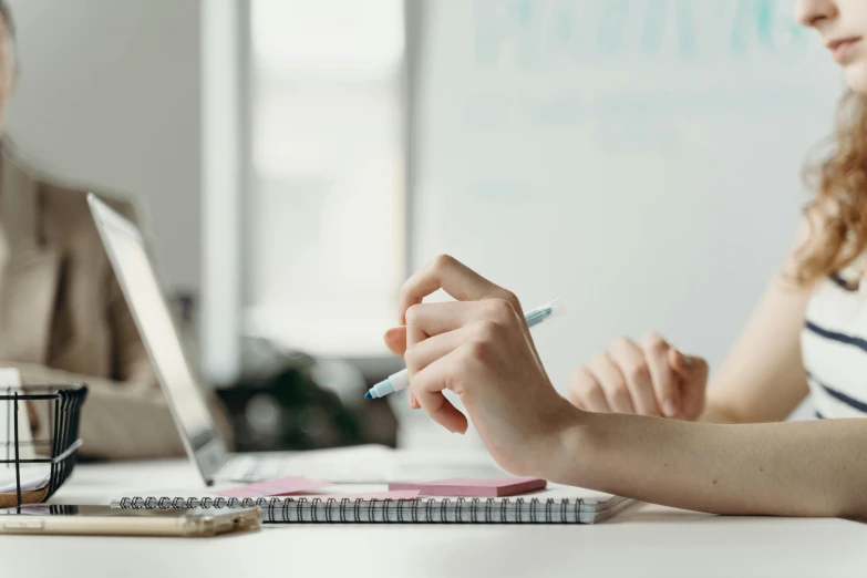 a close up of two people with a laptop on a desk