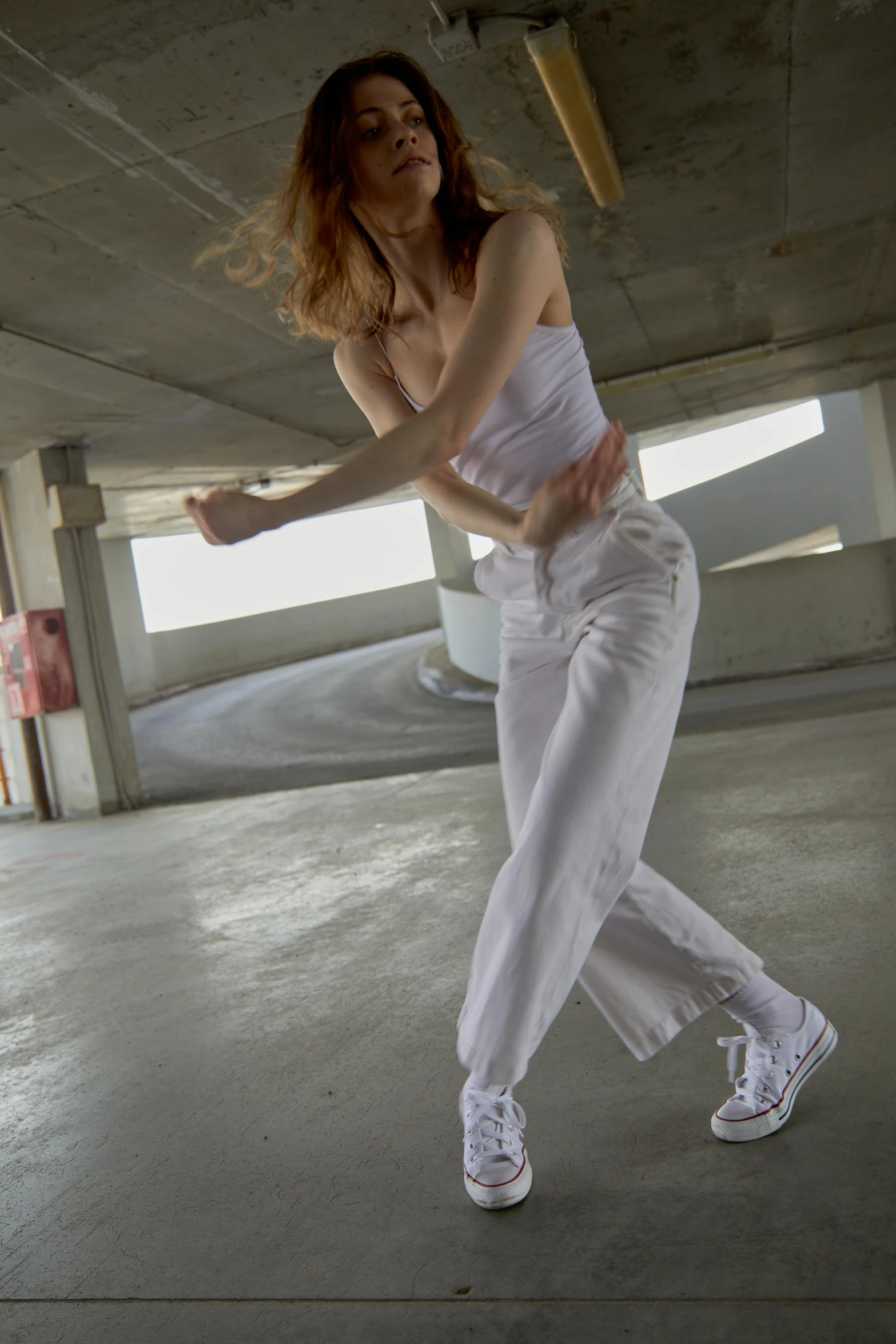 woman in white on floor posing for pograph