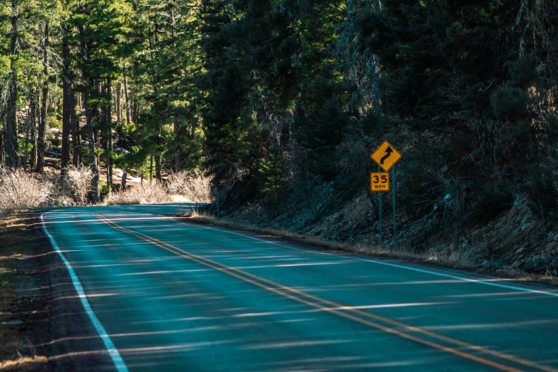 a very long road with some signs on it