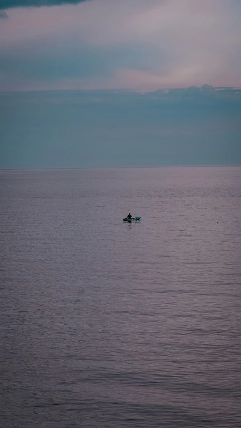 a small boat is seen in the distance on the water