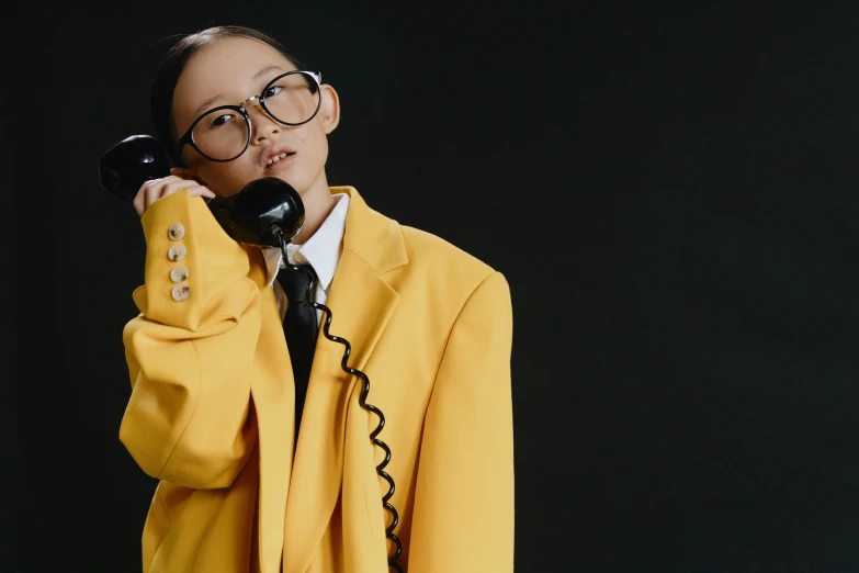 a woman in a suit talking on a phone