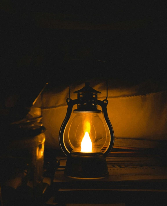 lit wax bottle sitting in a dark room