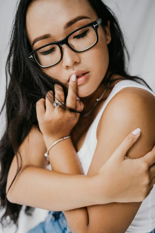 a beautiful woman in glasses with a cigarette in her mouth