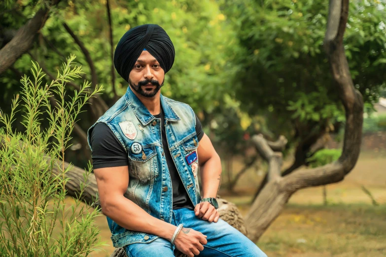 a man in a turban sitting on a rock