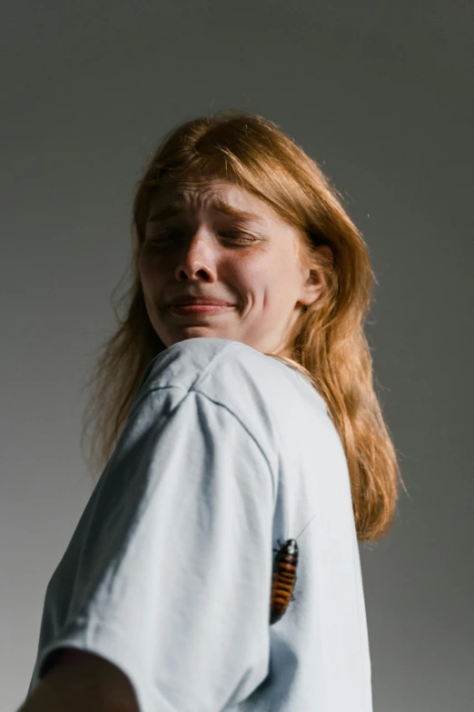 woman in blue shirt with brown striped tie