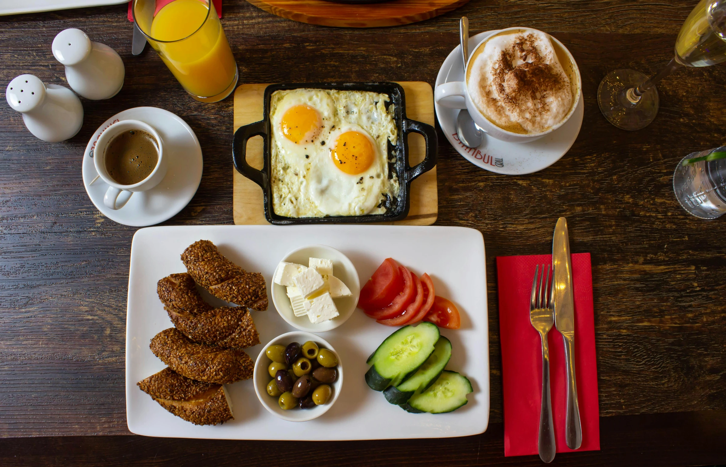 an assortment of food on plates, with beverages on the side